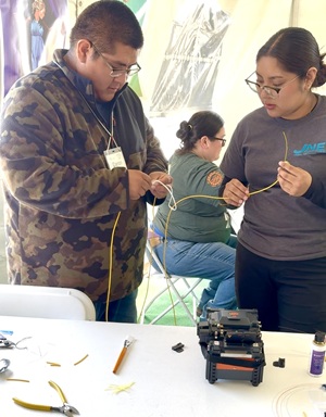 TBB Fiber Fix 3 Two young JNET technicians in training work side by side to splice fiber