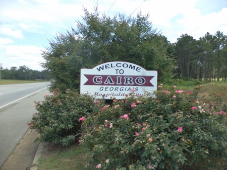 Cairo GA welcome sign Roadside sign surrounded by bushes reads: Welcome to Cairo, Georgia