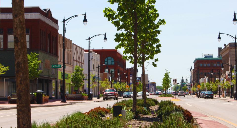 Daytime view of Superior downtown with low rise buildings on each side of Tower ave