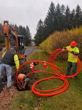 Construction crew installs fiber in a right-of-way on side of the road in Dryden NY